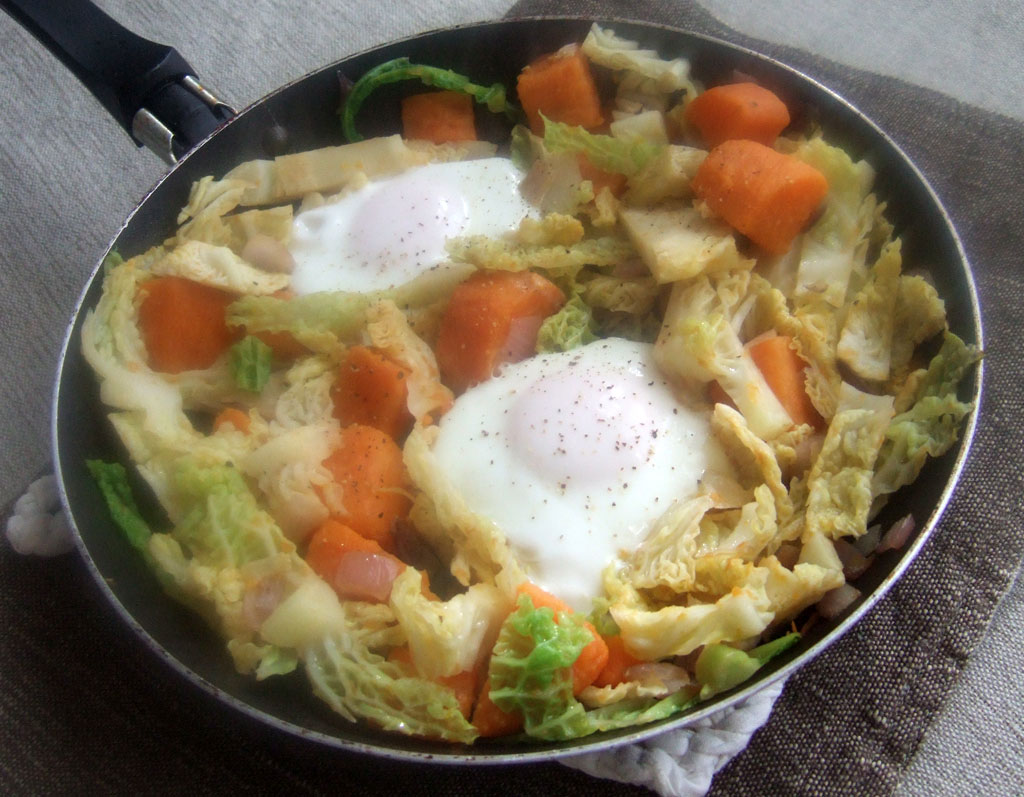 Sauteed sweet potatoes and cabbage with fried eggs